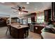 Open kitchen with an island, wood cabinetry, stainless steel appliances, and breakfast bar seating at 706 S Timberlane Dr, New Smyrna Beach, FL 32168