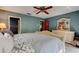 Main bedroom suite with a comfy bed, a dresser, and views to the outdoors at 706 S Timberlane Dr, New Smyrna Beach, FL 32168