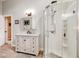 Bright bathroom featuring a glass shower, modern vanity with marble countertops, and a mirrored medicine cabinet at 706 Sky Tree Ct, New Smyrna Beach, FL 32168