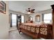 Bedroom features cozy carpeting, a rustic bed frame, a dresser with mirrors, and two windows with natural light at 706 Sky Tree Ct, New Smyrna Beach, FL 32168