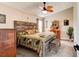 Bedroom boasts a rustic wood bed frame and a stylish ceiling fan, creating a cozy and inviting atmosphere at 706 Sky Tree Ct, New Smyrna Beach, FL 32168