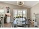 Dining room features a large window, hardwood floors, and seamless transition to the kitchen area at 706 Sky Tree Ct, New Smyrna Beach, FL 32168