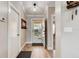 Bright entryway with hardwood flooring, neutral walls, and a view to the exterior through a glass front door at 706 Sky Tree Ct, New Smyrna Beach, FL 32168
