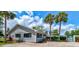 Charming community building with palm trees and vibrant landscaping under a bright blue sky at 706 Sky Tree Ct, New Smyrna Beach, FL 32168