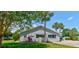 Community clubhouse exterior featuring lush landscaping and a parking lot, providing a welcoming community space at 706 Sky Tree Ct, New Smyrna Beach, FL 32168