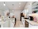Modern kitchen featuring white cabinetry, granite countertops, stainless steel appliances, and ample counter space at 706 Sky Tree Ct, New Smyrna Beach, FL 32168