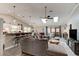 Open-concept living room with vaulted ceilings, skylights, hardwood floors, and a seamless transition to the kitchen at 706 Sky Tree Ct, New Smyrna Beach, FL 32168