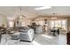 Inviting living space with hardwood flooring, comfortable seating, and seamless flow to the kitchen and dining area at 706 Sky Tree Ct, New Smyrna Beach, FL 32168