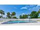 Refreshing community pool with ample lounge chairs and lush tropical surroundings at 706 Sky Tree Ct, New Smyrna Beach, FL 32168