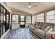 Relaxing sunroom with abundant natural light, comfortable seating, and access to the backyard for peaceful enjoyment at 706 Sky Tree Ct, New Smyrna Beach, FL 32168