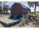Charming backyard shed with a small deck, perfect for storage and outdoor projects at 825 E 23Rd Ave, New Smyrna Beach, FL 32169