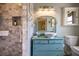 Updated bathroom with a walk-in shower and a blue vanity with a vessel sink at 825 E 23Rd Ave, New Smyrna Beach, FL 32169