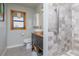 Bathroom featuring modern fixtures, a dark wood vanity, and gray tile at 825 E 23Rd Ave, New Smyrna Beach, FL 32169