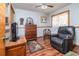 Bedroom with a ceiling fan, hardwood floors, and a comfortable armchair at 825 E 23Rd Ave, New Smyrna Beach, FL 32169