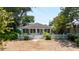 Charming single-story home featuring a white picket fence and lush landscaping at 825 E 23Rd Ave, New Smyrna Beach, FL 32169