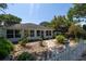 Inviting front yard with stepping stones and a white picket fence at 825 E 23Rd Ave, New Smyrna Beach, FL 32169