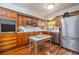 Kitchen featuring wood cabinets and stainless steel refrigerator at 825 E 23Rd Ave, New Smyrna Beach, FL 32169