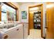 Bright laundry room with modern machines and organized shelving unit at 825 E 23Rd Ave, New Smyrna Beach, FL 32169
