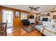 Warm living room with hardwood floors, a fireplace, and wood paneling at 825 E 23Rd Ave, New Smyrna Beach, FL 32169