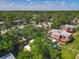 An aerial view showcasing the community landscaping, neighboring buildings, and mature trees at 95 Moonstone Ct, Port Orange, FL 32129