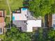 Birds-eye view of rooftop with light blue painted squares and a small patio area surrounded by trees and green space at 95 Moonstone Ct, Port Orange, FL 32129