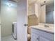 Bright bathroom featuring a single sink vanity and adjacent laundry closet at 95 Moonstone Ct, Port Orange, FL 32129