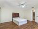 Bright bedroom featuring a queen bed and wood floors at 95 Moonstone Ct, Port Orange, FL 32129