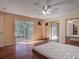 The main bedroom has wood floors, double mirrored closets and access to the balcony at 95 Moonstone Ct, Port Orange, FL 32129