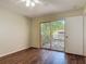 The bedroom features wood floors, ceiling fan and access to the outside deck at 95 Moonstone Ct, Port Orange, FL 32129