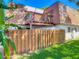 Two-story home featuring a balcony, wood fence, and vibrant green grass around the property at 95 Moonstone Ct, Port Orange, FL 32129