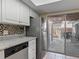 Bright kitchen with modern appliances, granite counters, mosaic backsplash, and access to a private patio at 95 Moonstone Ct, Port Orange, FL 32129
