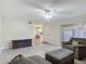 Comfortable living room featuring wood-look tile flooring, a ceiling fan, and a sliding glass door to the patio at 95 Moonstone Ct, Port Orange, FL 32129