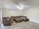 Comfortable living room features tile floors, ceiling fan and plush brown sectional at 95 Moonstone Ct, Port Orange, FL 32129