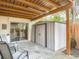 Enclosed patio with seating, storage shed, wooden fence, and outdoor lighting at 95 Moonstone Ct, Port Orange, FL 32129