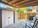 Enclosed patio featuring a storage shed, seating, wooden fence, and outdoor lighting at 95 Moonstone Ct, Port Orange, FL 32129