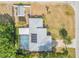 A captivating aerial view displays a screened pool, solar panels, and the home's layout at 995 16Th St, Edgewater, FL 32132