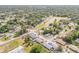 A wide aerial shot showcases houses surrounded by trees, with a pond and city views at 995 16Th St, Edgewater, FL 32132