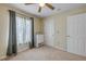 Bedroom with beige walls, carpeted floors, window with curtains, and white storage unit at 995 16Th St, Edgewater, FL 32132