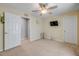 A simple carpeted bedroom featuring neutral walls, ceiling fan, and two entry doors at 995 16Th St, Edgewater, FL 32132