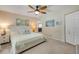 Cozy bedroom with neutral walls, carpet, ceiling fan, and charming coastal decor at 995 16Th St, Edgewater, FL 32132