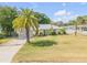 Charming single-story home with a well-manicured lawn and mature palm tree adding curb appeal at 995 16Th St, Edgewater, FL 32132