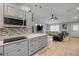 Open-concept kitchen and living room featuring tile floors, gray cabinets, and modern furnishings at 995 16Th St, Edgewater, FL 32132