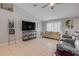 Bright living room with neutral tones, tile flooring, and a ceiling fan for added comfort at 995 16Th St, Edgewater, FL 32132