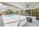 Screened-in pool area with a covered patio and outdoor seating perfect for entertaining at 995 16Th St, Edgewater, FL 32132