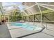 Outdoor pool in screened enclosure, enhanced by lush greenery, and inviting seating at 995 16Th St, Edgewater, FL 32132