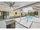 A sunny pool area with a screened enclosure and cozy outdoor seating at 995 16Th St, Edgewater, FL 32132