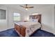 Comfortable bedroom featuring blue carpet with a double bed, dresser, and a large window at 114 Hickory St, New Smyrna Beach, FL 32168