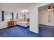 Bright bedroom with blue carpet, a double bed, and windows that provide plenty of natural light at 114 Hickory St, New Smyrna Beach, FL 32168
