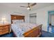 Bright bedroom features wood frame bed, ceiling fan, and closet at 114 Hickory St, New Smyrna Beach, FL 32168