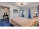 This bedroom features blue carpet, neutral walls, a vanity table, and dresser and a double bed at 114 Hickory St, New Smyrna Beach, FL 32168